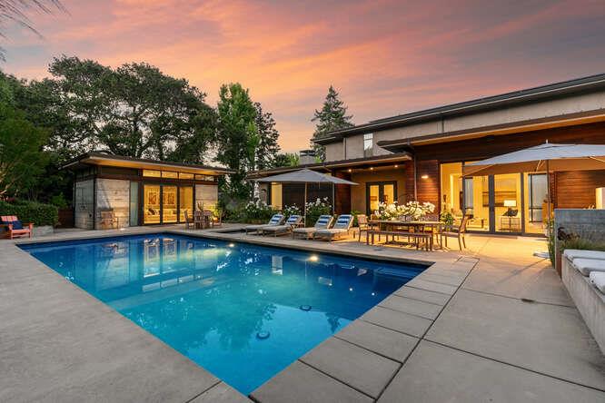 2016-built contemporary masterpiece on a premier street in lower North Hillsborough. Sustainable design by architect Dan Phipps, built by Toboni Builders with solar power, radiant-heated concrete or oak floors, wiring for EV, and radiant deck heated salt water pool on just over one-half acre. Native landscaping, Corten steel walls, and Ipe wood exterior. Accent walls, cabinetry, and doors all in gorgeous walnut and ceilings up to 20 feet. Formal dining room plus tremendous great room with modern kitchen designed for home chef, private chef, and caterers. Primary suite, secondary suite, and office on main level + 2 beds and bath upstairs along with customized study center. Lower level rec room, bath & temp-controlled custom wine cellar. Outdoor oasis includes pool house with bath (potential ADU), BBQ kitchen, fireplace terrace, level lawn, pool & spa + vegetable garden & fruit trees. Excellent Hillsborough public and private schools.