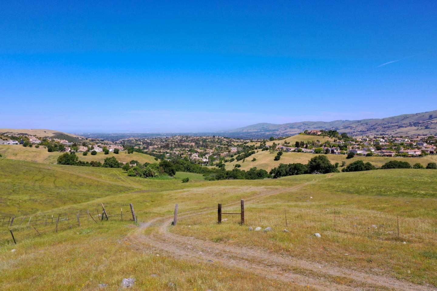 Welcome to the rolling golden hills of Sunrise Ranch. Located adjacent to the hillside estates of prestigious Silver Creek in San Jose, these approximately 103 acres are ready for your ideal ranch estate, family compound, or development project. Feels like a natural retreat away from the stresses of busy San Jose, but abutting the city limits and the greater Silicon Valley. A total of nine separate APN parcels grants many unique options for potential future development. The breathtaking panoramic views from the top parcels are not to be missed. There is already power, septic, and a well which serve a small existing home on the property.