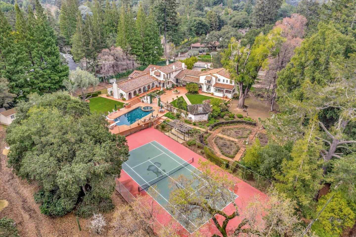 Welcome to this spectacular Spanish Colonial Estate sitting on over 2 flat acres of manicured grounds. It was the cherished home of a Silicon Valley Pioneer and his family for over 50 years! The 1930s home was preserved and additions were done by local craftsmen to capture the essence of the original home. Beautiful stucco old-world wall finishes-terracotta tiled floors, hand hewed wood-beamed ceilings, arched doorways, iron light fixtures, solid wood doors & stairs, iron railings, picture windows and so many fabulous details. Enjoyed and cherished by three generations. MAIN HOUSE 4 Bedrooms, 4.5 Bathrooms 4,391 sq. ft. ATTACHED RECREATION ROOM 1,326 sq ft.. 1 BEDROOM + GREAT ROOM APARTMENT 950 sq. ft. GARAGE 1,034 sq.ft. Top-rated Saratoga schools nearby. More photos, 3dtour, floorplan and video at www.19490GlenUnaDrive.com