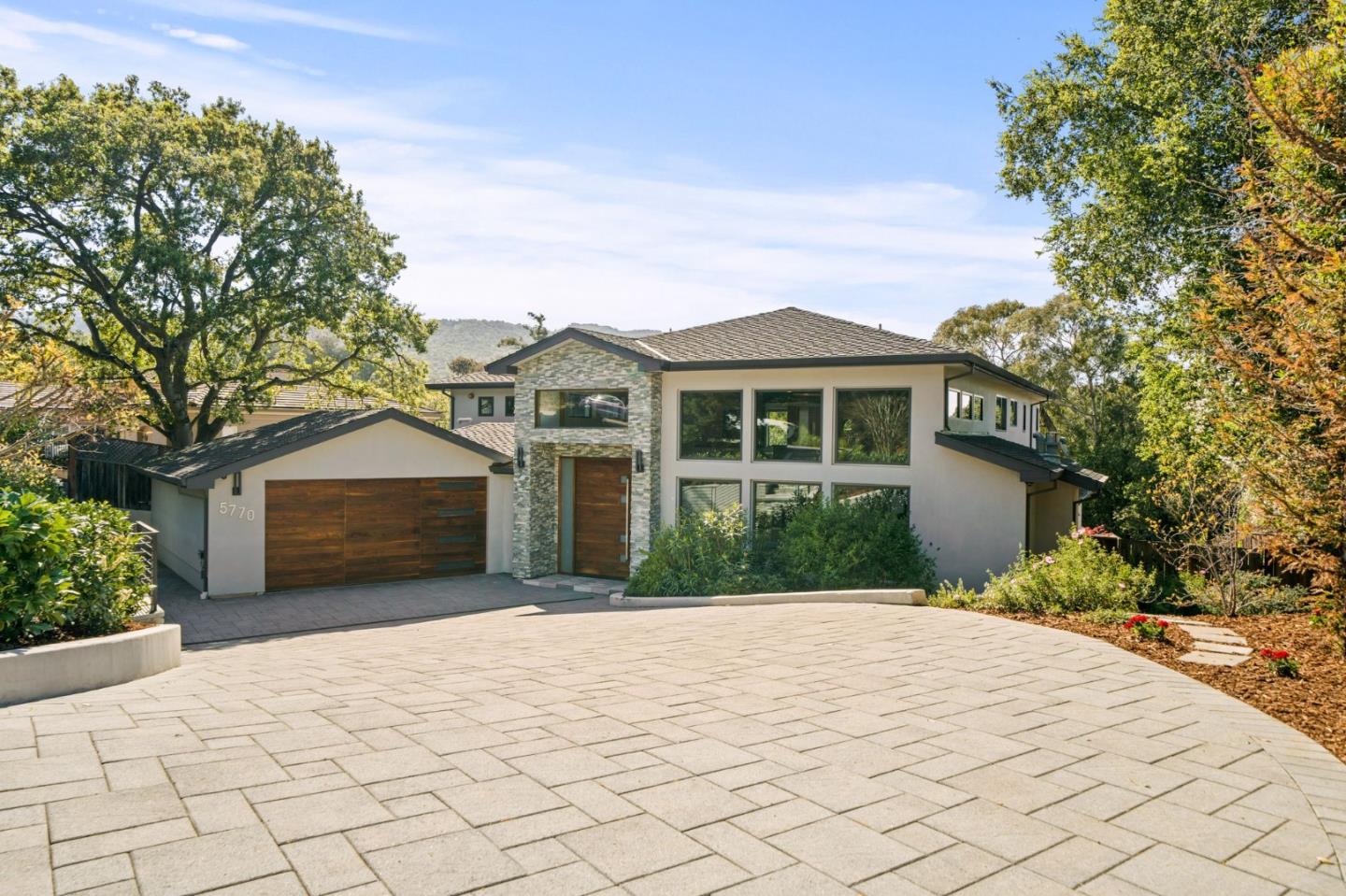 Welcome to your Los Altos Oasis! Built in 2015, this custom home boasts 5 bedrooms, 2 offices, an oversized basement, 5 full bathrooms, 2 powder rooms across 6,451 square feet of living space. Enjoy a half-acre lot with stunning tree-lined views. Inside, a grand entry leads to a living room with a cozy fireplace. The great room seamlessly combines kitchen, dining, and family areas, flowing to the patio and backyard. Hardwood-inspired tiles grace the floors, while the kitchen features high-end Wolf/Sub-Zero appliances and a walk-in pantry. The basement offers entertainment as a movie theater, bar or game room. Retreat to the primary bedroom with views, a walk-in closet, and a luxurious bathroom. Top-rated schools and quick access to private schools make this location ideal. Outside, a pool, jacuzzi, and multiple sitting areas await. Don't miss your chance to call this meticulously crafted home yours!