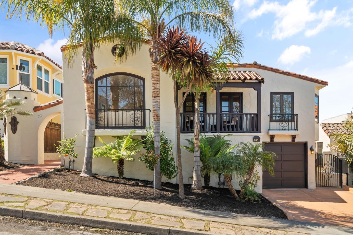 Located a short walk from downtown and top schools, 331 Elder Avenue in Millbrae Highlands boasts undeniable curb appeal and a blend of Mediterranean design with modern luxuries. This elegant home features a grand living room with lofty ceilings and large windows that brighten the space, highlighting the sleek hardwood floors. The kitchen is equipped with stainless steel appliances, granite countertops, and custom cabinets, adjacent to a formal dining room with a walk on balcony overlooking the cityscape.  Each bedroom offers a tranquil retreat, particularly the spacious primary bedroom with stunning views of the beautiful yards and a luxurious bathroom including a soaking tub and glass shower. The property features beautifully landscaped gardens in the serene backyard with patios ideal for relaxation or entertaining.  Situated on a prime block, this home provides easy access to excellent schools, dining, and shopping, making 331 Elder Avenue not just a residence, but a sanctuary that perfectly combines luxury, convenience, and character for a distinguished lifestyle in Millbrae.