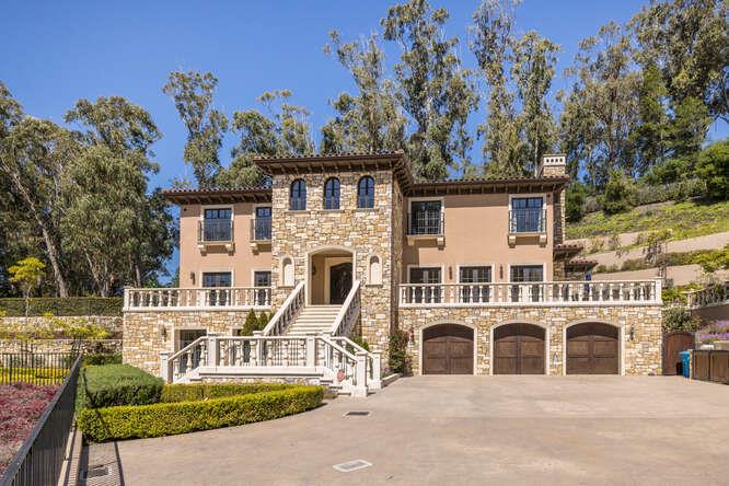 This exquisite three-story villa is nestled on nearly two acres of stunning gardens that capture the essence of Italy. The villa features interiors of unmatched quality with materials sourced globally, including fine woodwork, sleek lighting, and premium natural stone that exemplify modern sophistication. The grand entrance welcomes you with high ceilings and an office adorned with coffered ceilings. The master bathroom showcases a remarkable old-world charm. The state-of-the-art kitchen is equipped with a large island, and the lower level boasts a wine cellar, a full bar, and spaces for entertainment and media. Balconies, patios, and terraces offer views of a resort-like backdrop. The home is equipped with radiant heating, Sonos sound system, and a video security system. An outdoor kitchen with a dining bar, three fireplaces, and a saltwater spa enhance the luxurious outdoor living. Secluded by the orchard, there is a one-bedroom, self-contained guest house with an eat-in kitchen. This estate offers vast space, privacy, and opulence, making it a rare gem on the market.