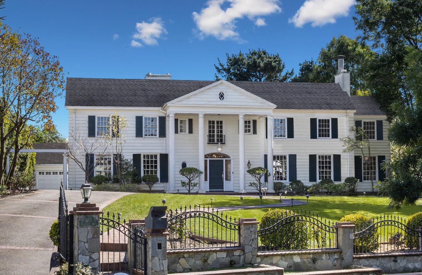 Magnificent Colonial Revival Mansion, designed by renowned architect Henry Gutterson, strategically placed on a 20,673 sqft corner lot; one of the three largest lots in St. Francis Wood. Most rooms are light-filled all day, with gorgeous sunset views over the Pacific Ocean. Revel in serene outdoor spaces with a large Pergola, stone terrace, raised gardens, lush landscaping, expansive lawns, and a tiered fountain. Built in 1924, this home retains much of its architectural charm with inspired modern updates throughout. The grand entry hall with a central staircase opens to the Living room, Dining Room, and the glass-roof Solarium. The award-winning Studio Snaidero Chef's Kitchen has top-of-the-line Miele stainless steel appliances, gas and steam ovens, dual pull-out dishwashers, an in-wall coffee system, and glass doors opening to the terrace. The main floor also hosts a Bedroom and Family/Media room with a wet bar. Ascending to the second floor, a Library and four en-suite Bedrooms - each with updated bathroom. The luxurious Primary Bedroom also has a walk-in closet and Dressing Room. A gated driveway, 10+ car parking, and outdoor kitchen further enhance the property. St Francis Wood parks, playgrounds, and tennis courts are nearby. Excellent schools. Some images virtually staged.