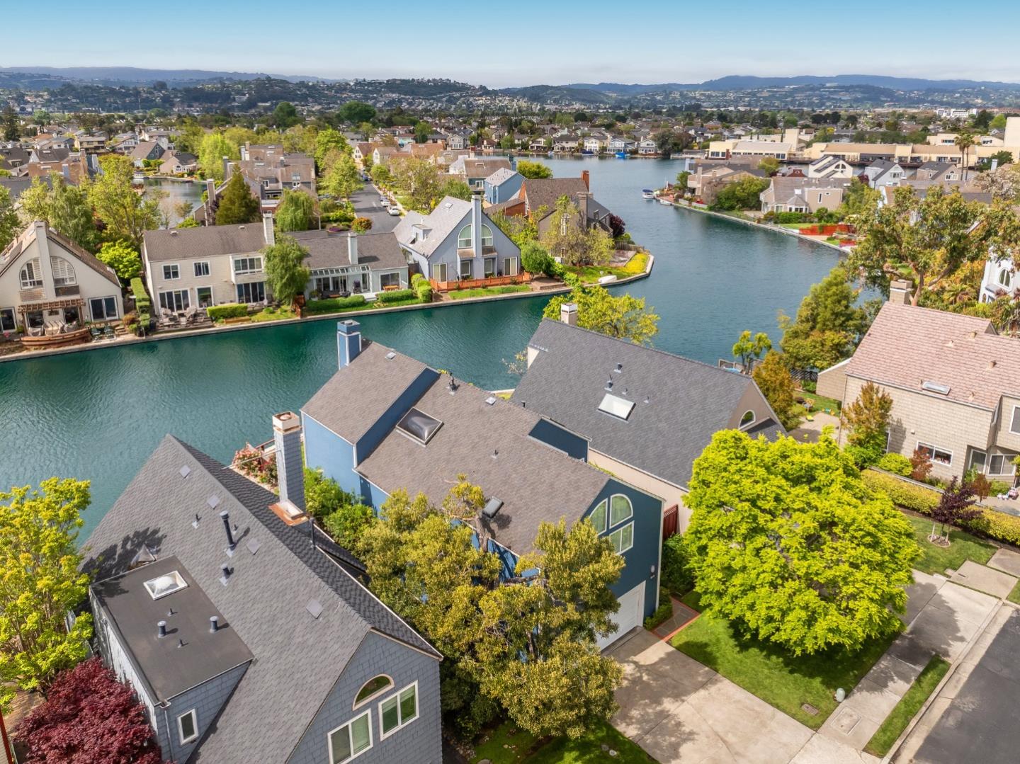 Ensconced in the prestigious enclave of Whalers Island and idyllically situated on the glistening aquamarine waters of Foster City lagoon, this spectacular 4BR/3.5BA residence is truly a luxurious private oasis. Magnificent elevated ceilings, clean contemporary lines, expansive windows, and distinctive architectural elements provide an exquisite backdrop for a captivating display of volume, scale, and radiant natural light. Thoughtfully designed to showcase scenic waterfront views and vibrant rear grounds, the cohesive floor plan harmoniously weaves formal and casual living spaces. Artfully pairing granite, tile, wood, and stainless steel, the bright remodeled eat-in kitchen is primely positioned off the family room, which grants access to the outdoor living area. Escape to the primary suite featuring a soaring half-vaulted ceiling, a water-facing balcony, walk-in closet, and dual vanities. A second impressive bedroom suite, two bedrooms, dedicated office, hall bathroom, and laundry room complete the upper level. Remarkable amenities include 2 pools, a kiddie pool, jacuzzi, 2 tennis courts, 2 pickle ball courts, a basketball court, picnic area, and a boat park. Experience Venetian living at its finest with an exclusive boat dock and 5 miles of meandering waterways to explore!