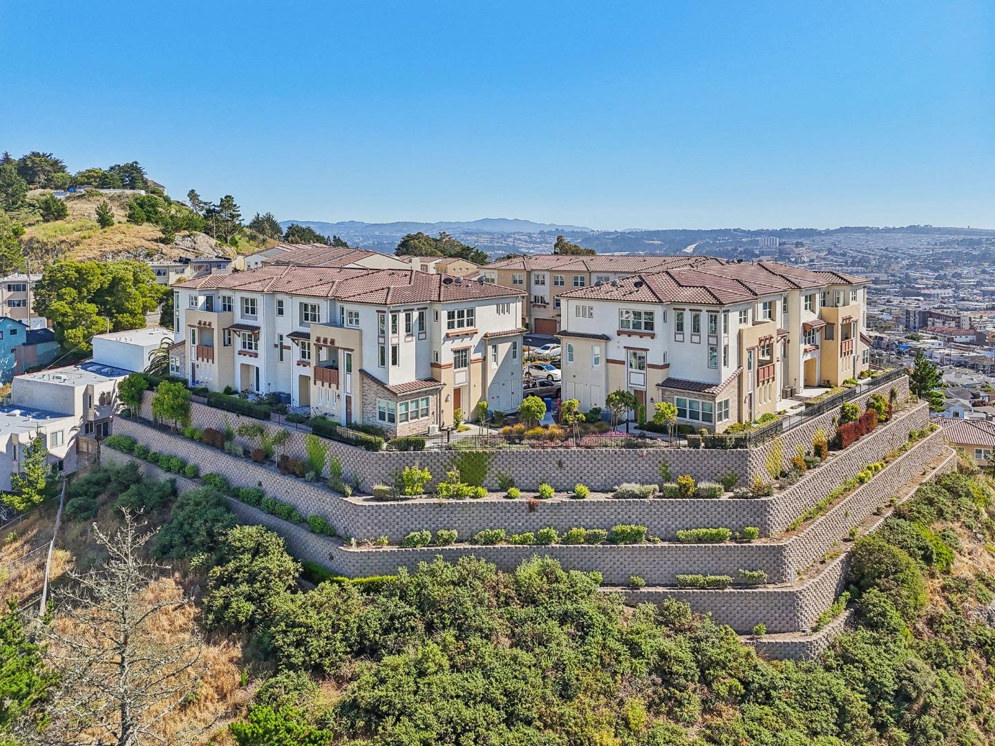 Spectacular unobstructed views of San Francisco and the Bay converge at this modern condominium masterpiece! Built in 2017 and located at the end of a quiet cul-de-sac in a gated private community at the top of the hill in Daly City! Contemporary modern open concept design featuring a total of five bedrooms and four full baths. Also included is a bottom floor one bedroom studio with full bath/half kitchen with separate entrance. This wonderful condominium is in the best location in the complex, featuring a bright, airy design with views from every window, soaring ceilings, recessed lighting, and hardwood floors. The gourmet kitchen features modern stone countertops, stylish cabinets, stainless steel appliances & breakfast bar. Enjoy the primary suite w/ spa like bath, deep soaker tub, dual vanity, large walk-in closet. Three other large bedrooms and two full bathrooms with laundry round out the main living space. Also featuring central zoned heating/AC, attached two car garage and much more. Located close to all major transportation routes (101/280/BART), downtown San Francisco, SFO and great shopping and dining.