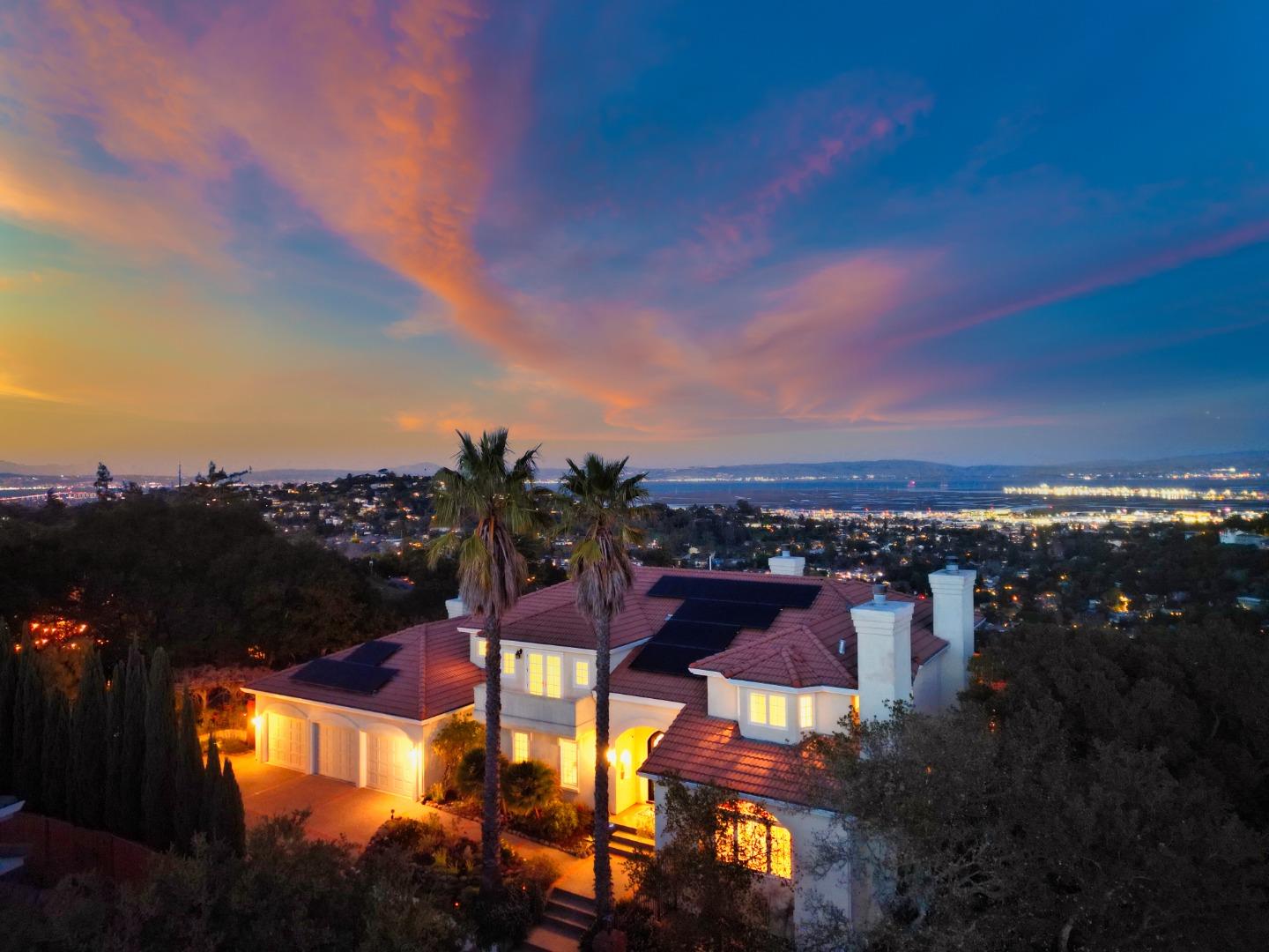 Majestically situated on a lush .47-acre lot at the end of a quiet, scenic cul-de-sac, this exquisite custom-built home commands attention with its Mediterranean-inspired design, impeccably manicured grounds, and breathtaking panoramic Bay views. Spanning over 6,500 square feet, the home boasts five bedrooms and five full bathrooms, offering a perfect balance of grandeur and warmth. The thoughtfully designed three-level floor plan features soaring ceilings, elegant marble finishes, and expansive windows that showcase stunning views from every room. Regal fireplaces and gleaming hardwood floors enhance the sophisticated yet inviting ambiance throughout the home. Outside, the grounds are a masterpiece of vibrant landscaping adorned with fragrant wisteria, heritage oaks, and romantic pathways. Sweeping view-facing decks, a level lawn area and an enchanting arbor create an idyllic outdoor retreat, perfect for relaxation or entertaining. Located just minutes from the dynamic energy of Silicon Valley, this rare and extraordinary home provides a peaceful sanctuary to unwind and recharge after a busy day. Welcome home!!!