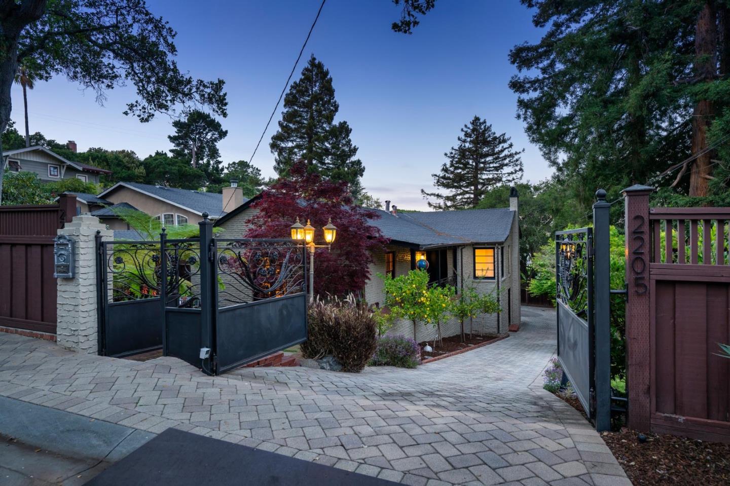 ***This exceptional property is being offered for sale in conjunction with the adjacent land lot at 2207 Semeria (included in list price)*** Welcome to your own gated, park-like oasis close to Belmont's amenities! This distinctive residence has undergone thoughtful renovations since its original construction with tremendous character in 1943. The estate is fully enclosed with a custom-built, electric gate and features fruit trees, lush foliage, multiple maples, and majestic redwoods. The included parcel offers its own set of unique features, including an impressive 18-foot-high gas stone fireplace, a massive lawn area, a large level sand patio and a cabana, making it ideal for entertaining. The main living room, over 400 square feet, exudes warmth with its charming wood-burning fireplace and leads to a bright sunroom. The home boasts 4 bedrooms and 2.5 bathrooms, including an oversized primary suite, complete with two walk-in closets and French doors leading to a magical patio. The lower-level features two additional bedrooms, a full bath, and a separate entrance. This property offers a rare combination of distinguished elegance and modern functionality, with a spectacular setting perfect for those seeking a private, peaceful retreat or a potential family compound.
