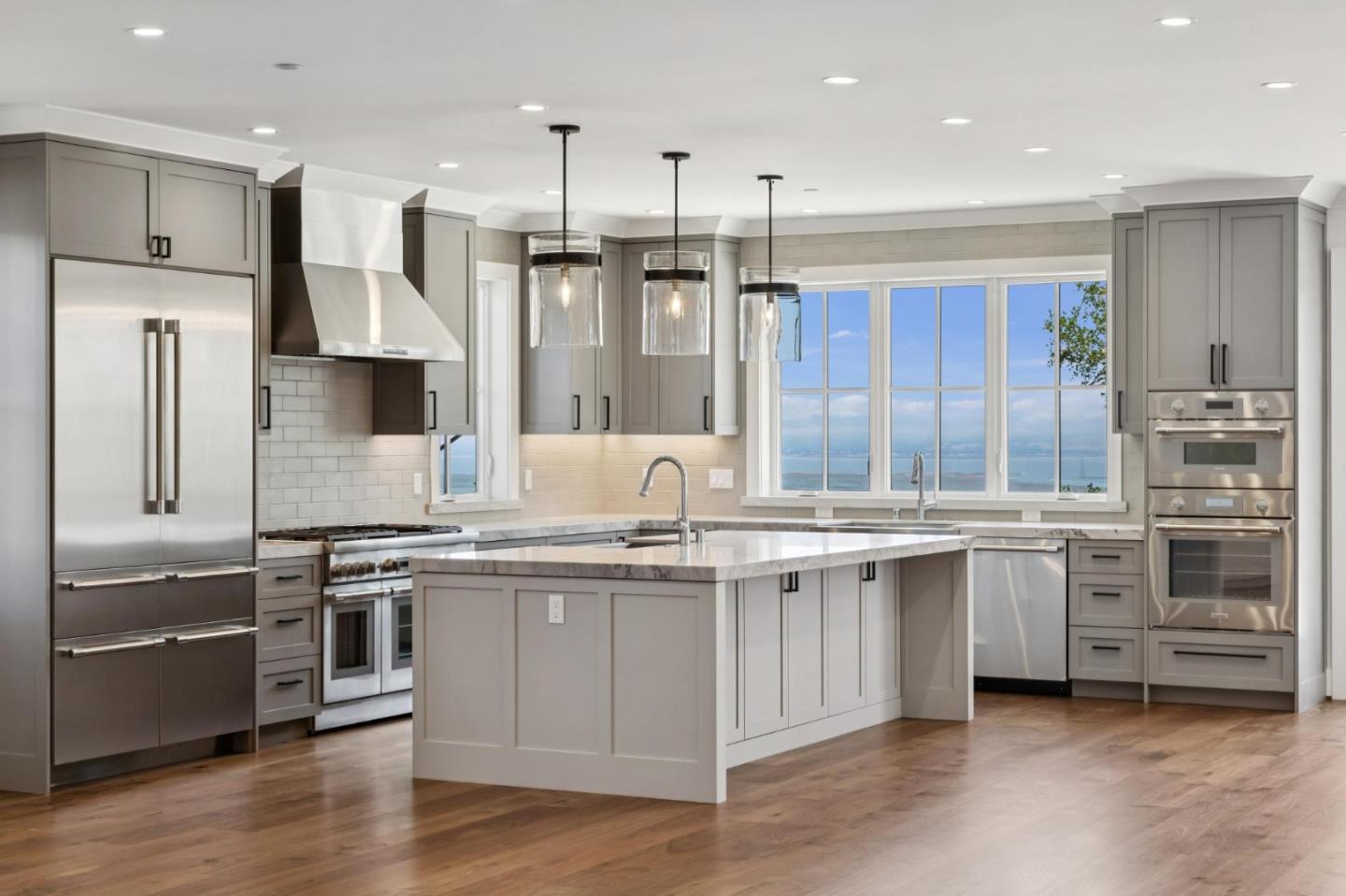 Artisan New Construction ~ Privacy ~ Bay View. "Not everything that matters can be measured."....A wide, private drive leads to a hidden retreat, a big view, and a soft quiet. Airy and modern, with high and vaulted ceilings, rich hardwood floors, and extensive use of natural materials, the design aesthetic transcends trends. The bay view teases from the formal entry, beguiles from the massive great room and endless kitchen, and entrances from the patio, backyard and upstairs primary suite. Each of the five bedroom suites has unique features; the stunning treehouse primary, with its sanctuary bathroom, finished walk-in closet, and covered view deck, is awash in a kaleidoscope of sunrises and evening lights. A stone-floored mudroom with a laundry area and walls of storage captures and calms the daily chaos, and a second laundry room upstairs doubles efficiency. Tangibles and intangibles are interworked in this new legacy property by seasoned local builders who are on site every day and involved in every inch and detail of the project. Ingenuity, skill and experience are as much a part of this striking, custom-built home as are timber, steel and concrete.