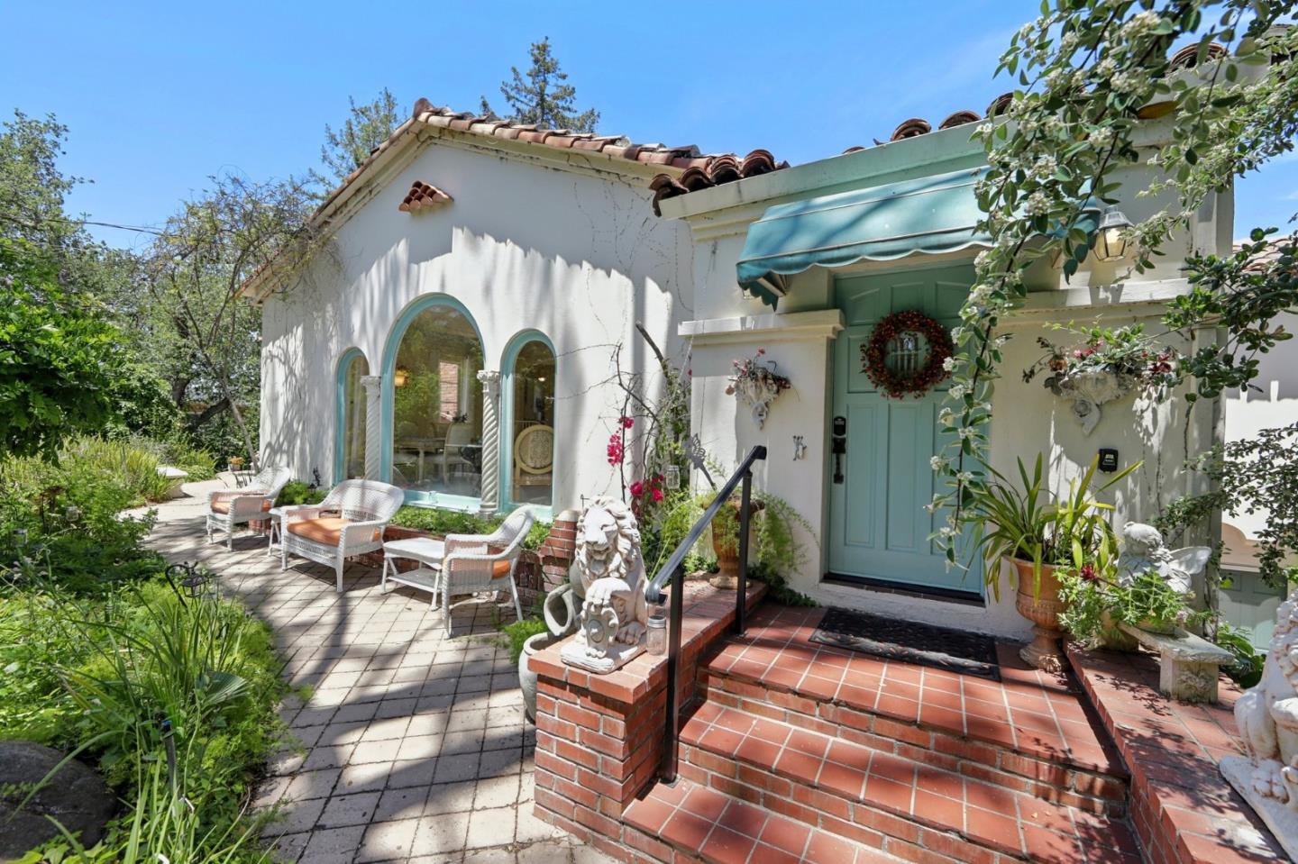 Discover a rare opportunity to own a charming Mediterranean estate nestled on 1.36 acres of serene, forest-like ground. Although the address is on the main street, this unique property is situated well back from the road, offering enhanced privacy. Located in one of the most coveted areas, this home beautifully blends tranquility with the convenience of city living. Step into a sanctuary where majestic oak and palm trees create a magical garden, a fishpond with a waterfall, and daily visits from hummingbirds, butterflies, dragonflies, rabbits, and even deer, making it feel like a fairytale. Featuring handmade Spanish clay roof tiles, This 3,603 sqft home offers exceptional versatility and an abundance of natural light, with views of the lush garden, mountains, and city lights; 5 entrances, 2 sliding doors, and 3 balconies. It features 4 bedrooms, 2 living rooms, office, plus indoor & outdoor fireplaces. The concrete stucco building's layout accommodates two separate living spaces. Easy & quick access to the highway. The lot offers the potential for ADU, pool, or other amenities, allowing you to customize the property to suit your needs. This property is a unique, rare gem where nature, history, and luxury converge, ready for its next chapter.