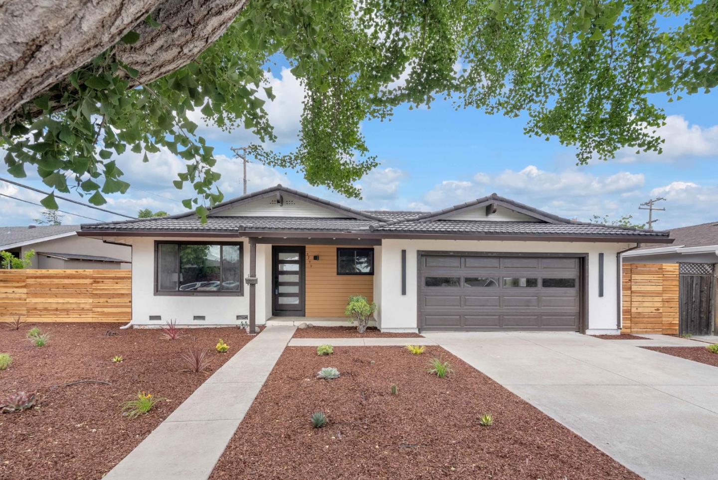 Located in a desirable San Jose neighborhood, this charming 4-bedroom, 2-bathroom home offers 1,516 sq. ft. of comfortable living space on a generous 7,560 sq. ft. lot. This home has been beautifully refreshed with brand-new flooring throughout the entire house, complemented by a completely remodeled kitchen and updated bathrooms.  The heart of the home is the open-concept kitchen and family room, featuring durable quartz countertops, a gas cooktop, a built-in microwave, and a cozy fireplaceperfect for gathering. Both full bathrooms are equipped with convenient shower-and-tub combinations. Additional features include central forced-air gas heating, a dedicated dining space, and a 2-car garage with laundry hookups. Situated in the sought-after Oak Grove Elementary School District, this turnkey property is ready for you to move right in.