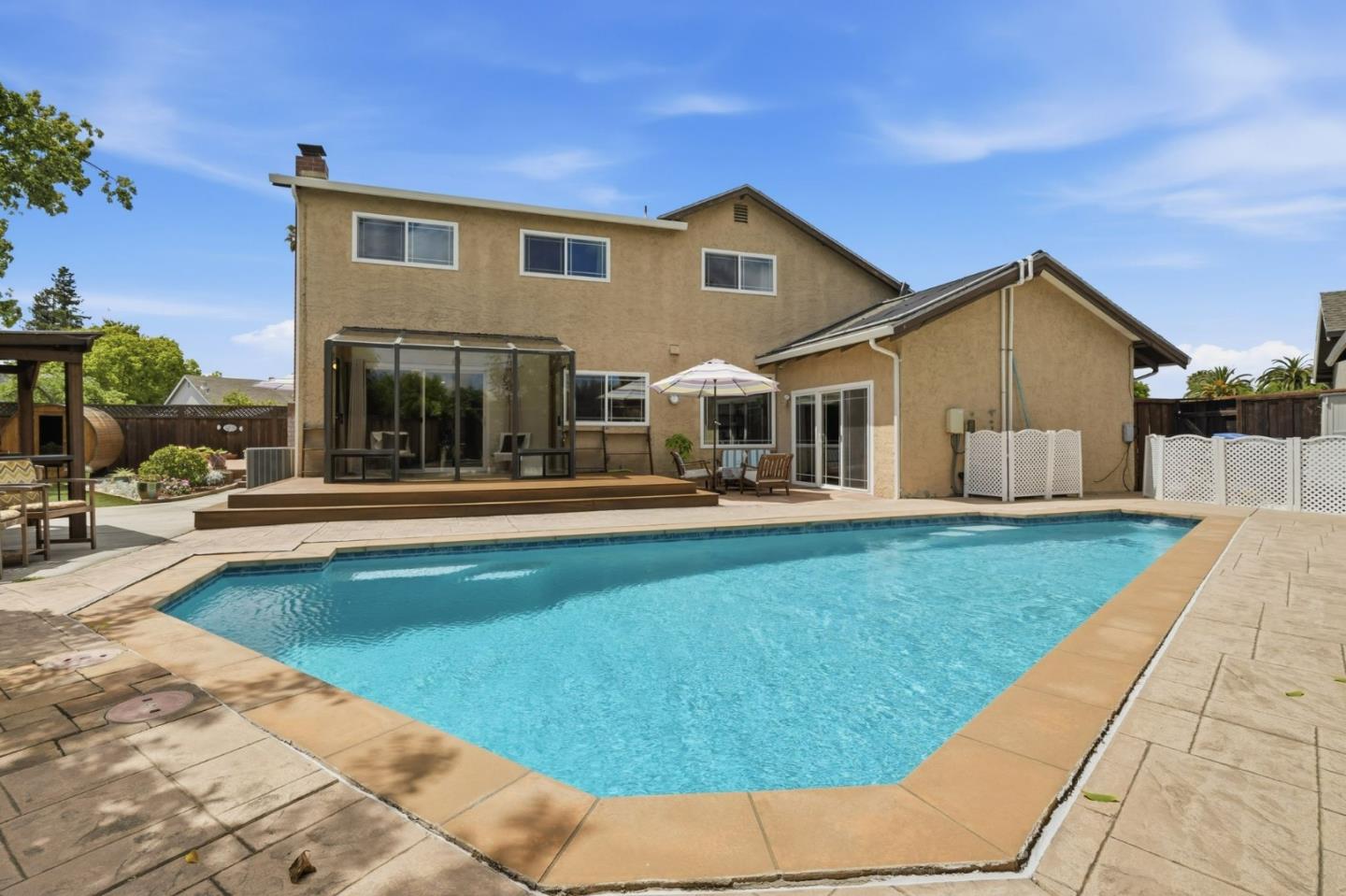 Thoughtfully upgraded inside and out, this spacious 4-bedroom, 2-bath single-family home offers approximately 2,170 sq ft of living space on an expansive 9,750 sq ft lot. Features include a beautifully remodeled kitchen with quartz countertops and updated appliances, renovated bathrooms, hardwood flooring, updated windows and doors, upgraded HVAC, solar panels, and refreshed landscaping. The impressive outdoor space is designed for relaxation and entertaining with two decks, an in-ground solar-heated pool, BBQ gazebo, steam sauna, paver driveway, and low-maintenance yard. Conveniently located near commute routes, parks, shopping, and everyday amenities. A move-in-ready opportunity!