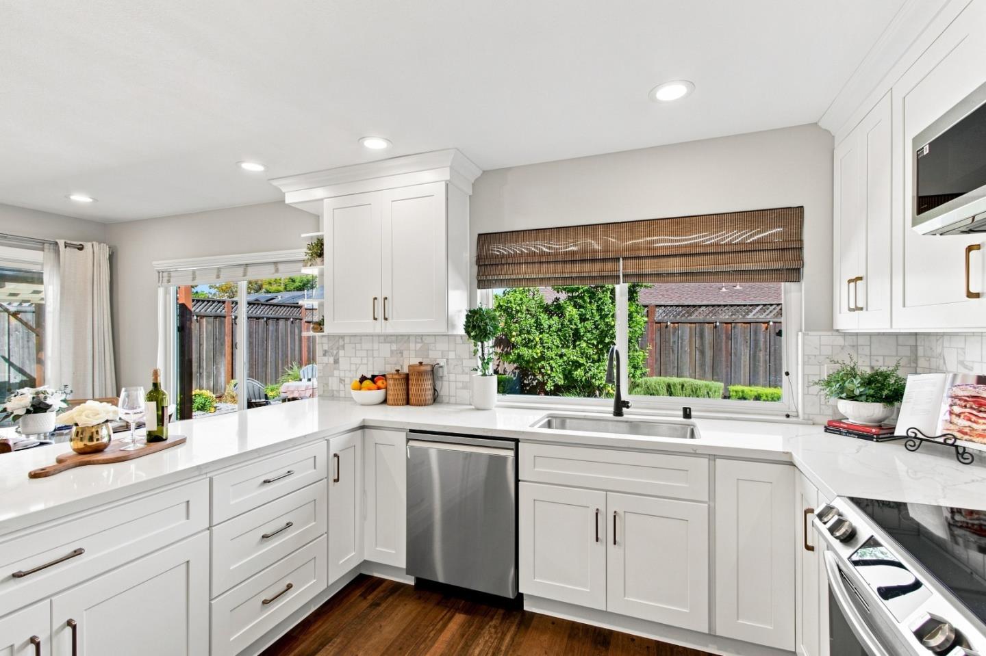 Extensively remodeled & set on a generous corner lot, this move-in-ready home offers something increasingly hard to find: abundant outdoor space & room to grow. Updated for the owners to enjoy, not simply for resale, the bright kitchen features ample white cabinetry, quartz counters, marble-look backsplash, stainless appliances, open shelving & generous peninsula connecting kitchen, dining & living spaces. Both baths have been stylishly remodeled with contemporary finishes, while rich walnut-tone LVP flooring creates warmth throughout. Smart lighting & thermostat add everyday convenience, but step outside & the property truly sets itself apart. Spacious, private backyard features lawn, mature landscaping, shaded pergola & fire pit room to dine, entertain, play, garden or simply relax. Beyond the backyard, an expansive side yard takes advantage of the corner lot, offering even more possibilities for outdoor living, future expansion or a potential ADU (buyer to verify). With the neighborhood park just one block away, shopping, dining & everyday conveniences nearby, plus easy access to Hwys 85/87, the location helps make busy days simpler and leaves more time to enjoy being home. Updated inside, spacious outside & flexible for the future this is everyday living, beautifully done.
