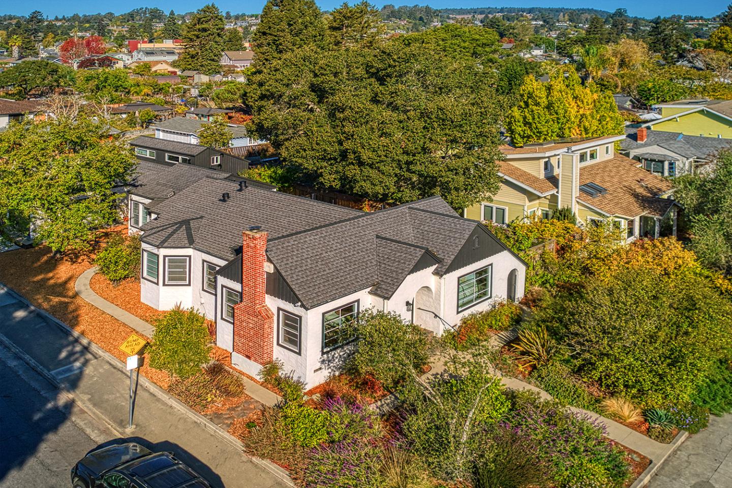 When you find a home you can walk or bike to the best of what Santa Cruz has to offer; West Cliff's scenic paths and beaches, a lively downtown community of great food, music and art, the local market and top K-12 schools, you know you've found an idyllic lifestyle to last a lifetime. For 5 decades, this California-style single-level bungalow (with a loft) has been cherished by one family maintaining its charm and character while remodeling and building more living and office space synthesizing a 1930s home with a hip, sensible 70s rustic Scandinavian-style addition. Through a gorgeous arched wood entry door you'll find a light-filled home with more interior arches, built-ins, stunning sconce lighting, gleaming wood floors, travertine, marble, granite, stone, stainless steel, pebble floors, gorgeous double pane wood windows, the largest barn door I've ever seen, and heaps of flexible space conducive to what your life needs. While there may be real development potential to convert the addition to an ADU and other building possibilities, moving straight in is an easy feat. The front and back yards are landscaped with drought-tolerant plants, a bubbling fountain and citrus fruit trees, while the side yard is a blank slate affording potential to add more outdoor entertaining space.